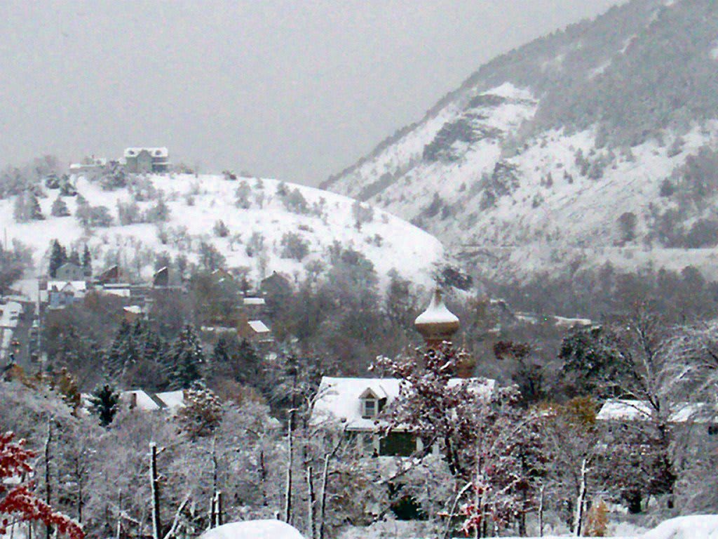 A snowy village nestled in the mountains during winter.