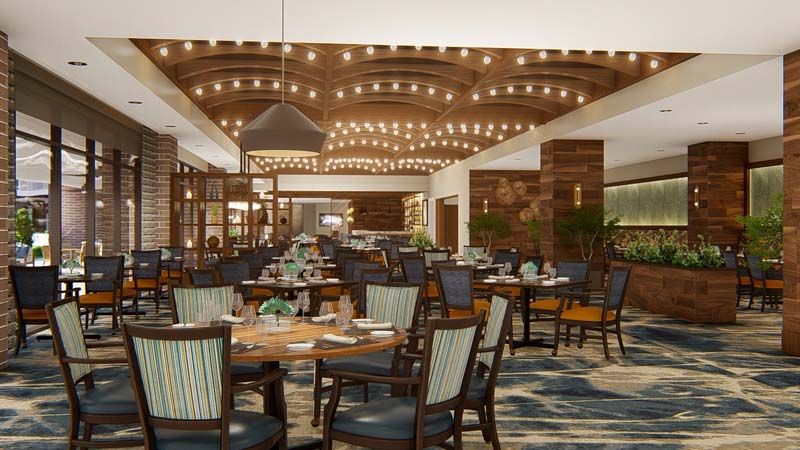 A warmly lit restaurant interior with elegant furnishings and decorative ceiling lights.