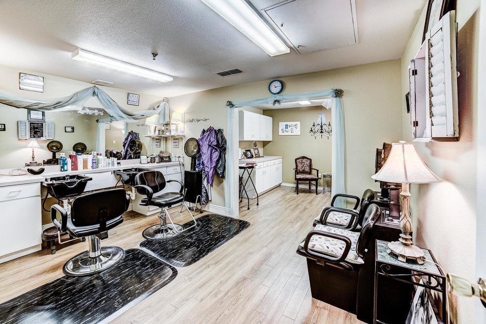A well-organized hair salon interior featuring styling chairs, mirrors, and various salon equipment.