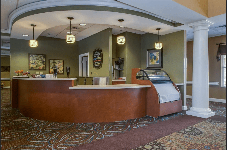 A warmly decorated hotel reception area with a front desk and welcoming atmosphere.