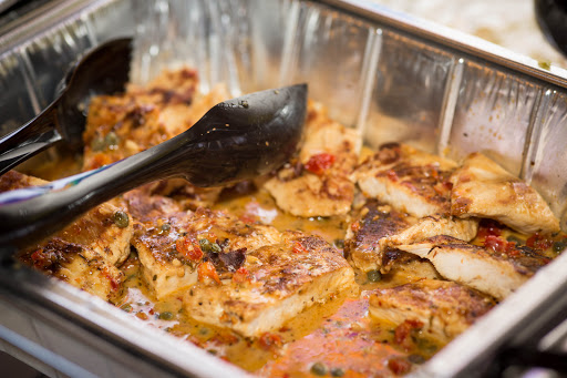 A delicious serving of seasoned baked fish, ready to be enjoyed.