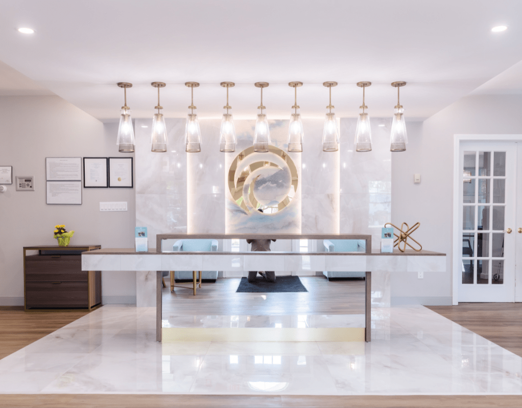A sleek and modern lobby with a minimalist reception desk and elegant lighting.