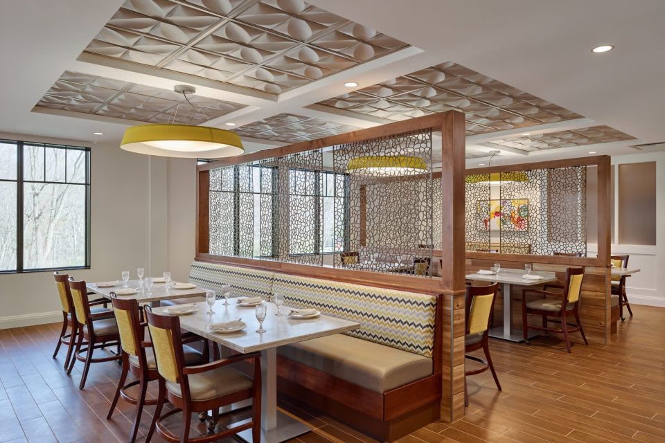 Modern restaurant interior with booth seating and stylish decor.