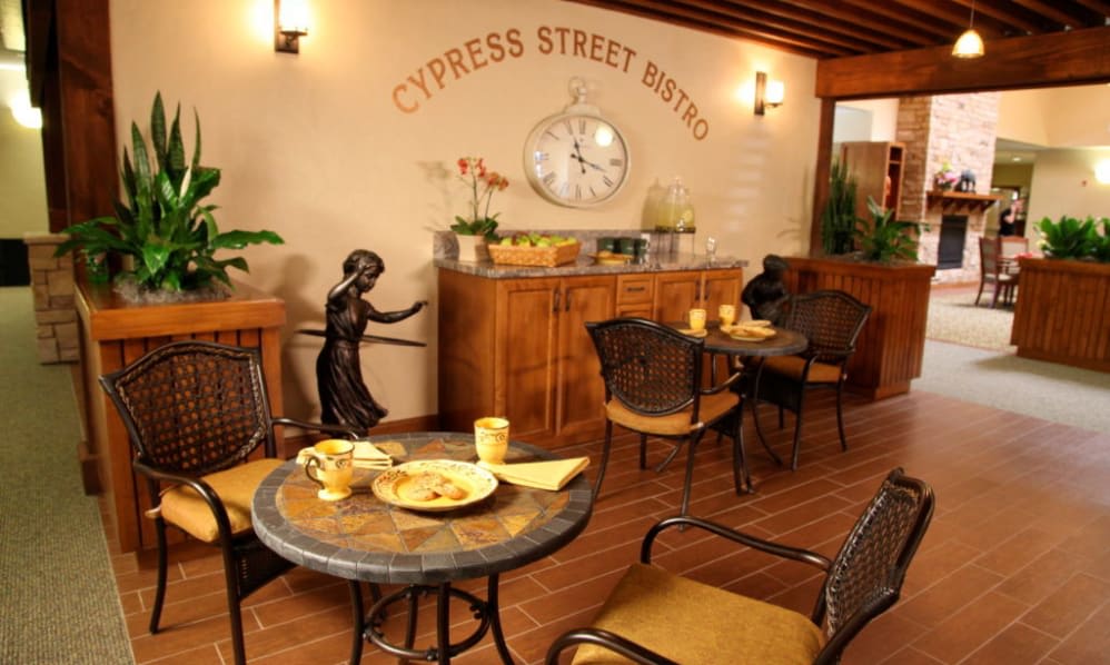 A cozy bistro interior with tables, chairs, and decorative elements.