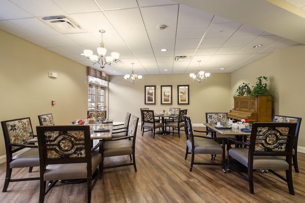 A cozy dining room with elegant furniture and soft lighting.
