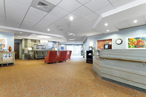 A spacious and modern lobby featuring comfortable seating and a reception desk.