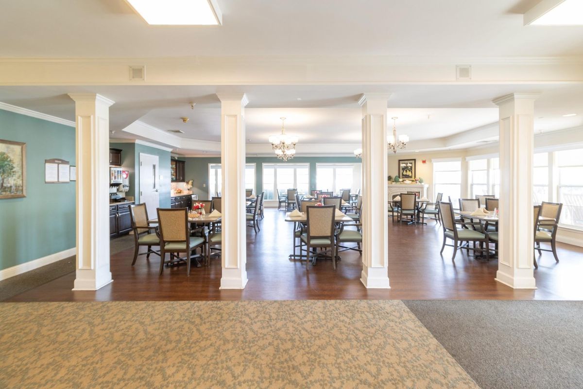 A spacious dining area with neatly arranged tables and chairs.
