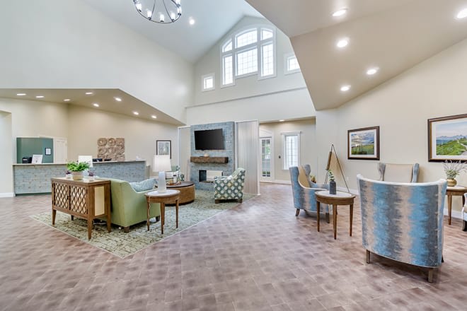 A spacious and modern living room with high ceilings and ample natural light.