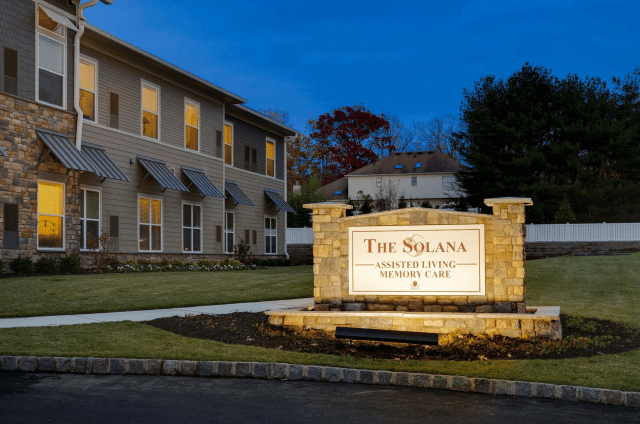 The Solana Senior Living facility at dusk with illuminated signage.