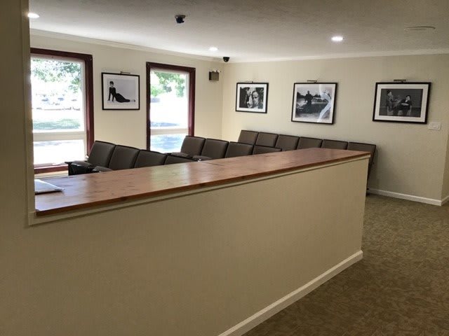 A cozy waiting area with comfortable seating and framed photographs on the walls.