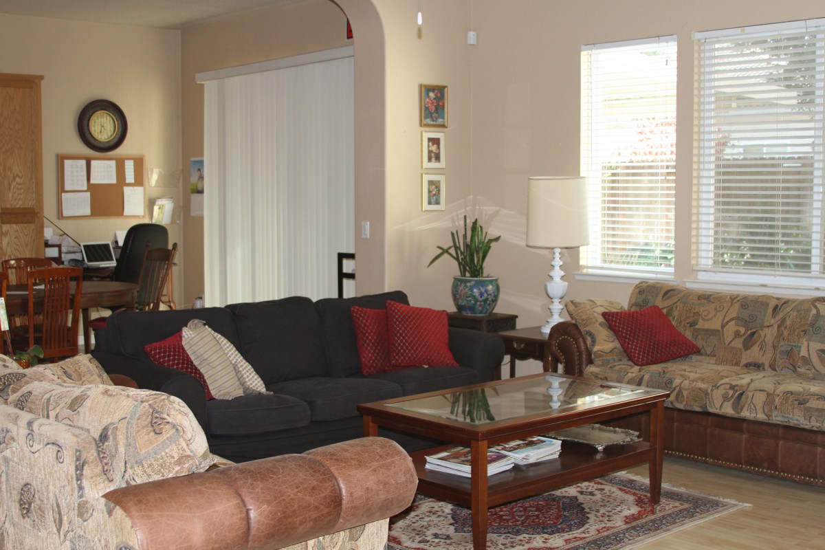 A cozy living room with a sofa, coffee table, and decorative elements.
