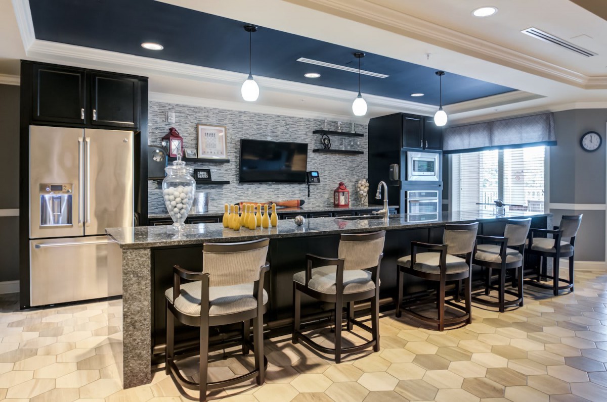 A modern kitchen with a sleek countertop and stylish bar stools.