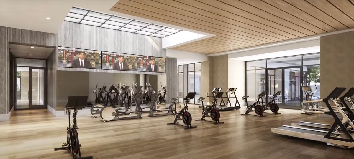 A modern and spacious gym with exercise bikes and treadmills.