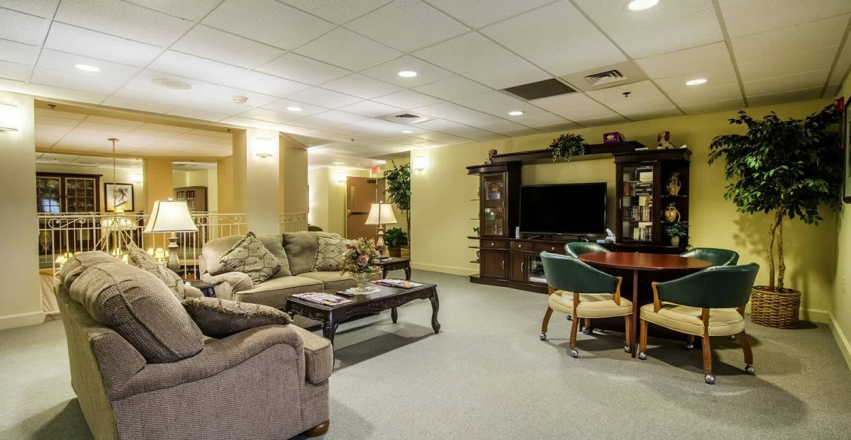 A cozy living room with comfortable seating and a large television.