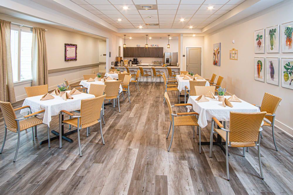 A modern dining area with neatly arranged tables and wooden chairs.
