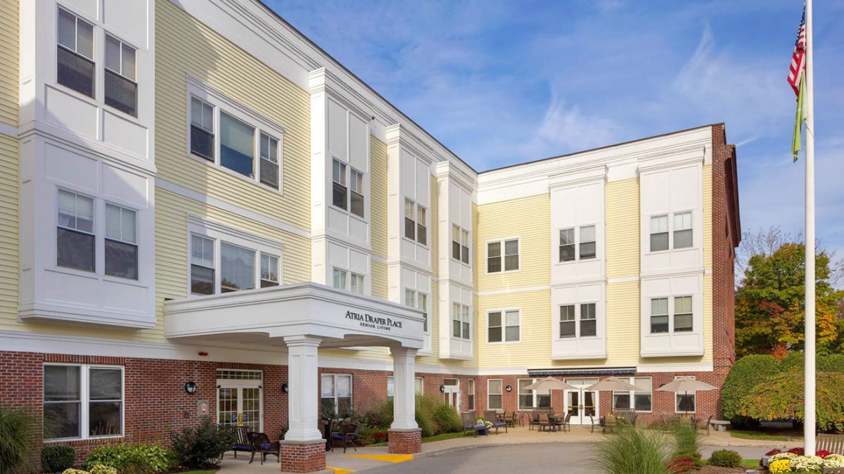 A multi-story residential building with a welcoming entrance and numerous windows.