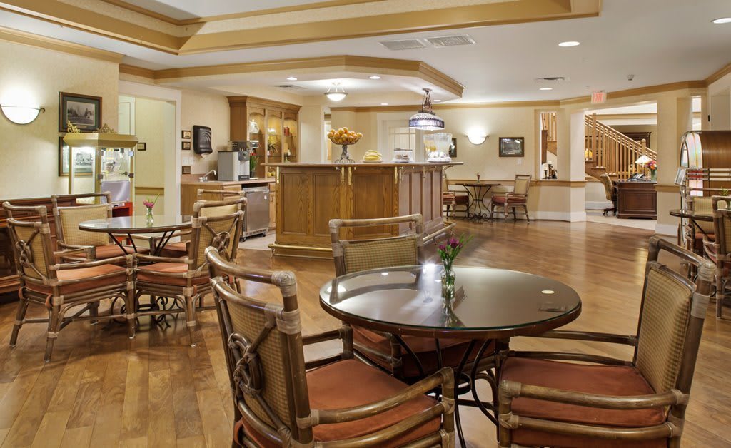 A cozy and elegant lobby area with wooden furniture and flooring.