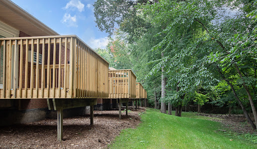 A serene wooden deck nestled among lush greenery.