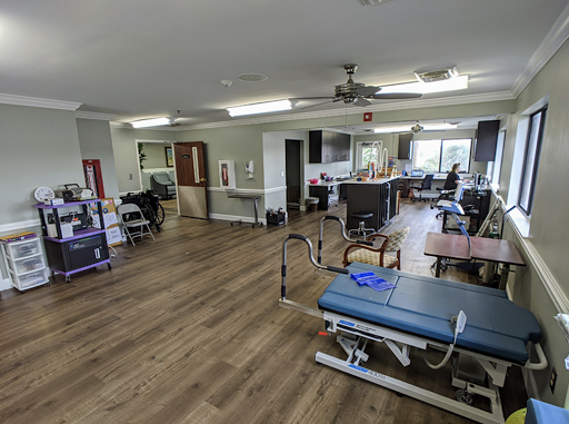A spacious rehabilitation center equipped for physical therapy sessions.