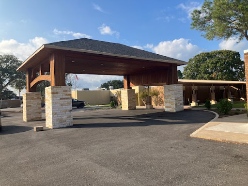 Welcoming entrance to a facility, showcasing a blend of modern and traditional architectural elements.