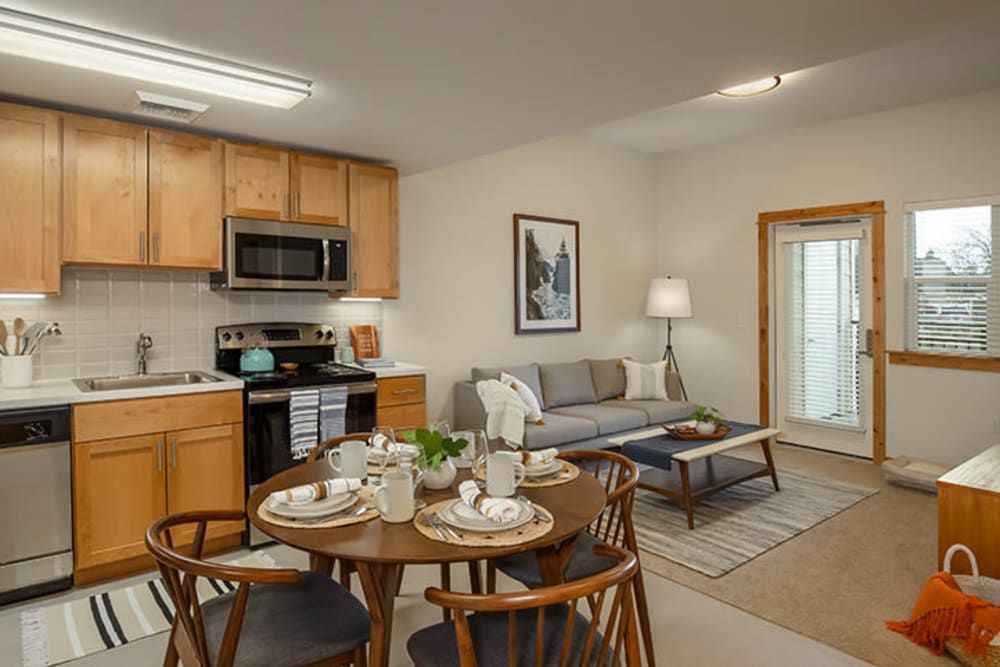 A modern, cozy apartment interior with an open living room and kitchen layout.