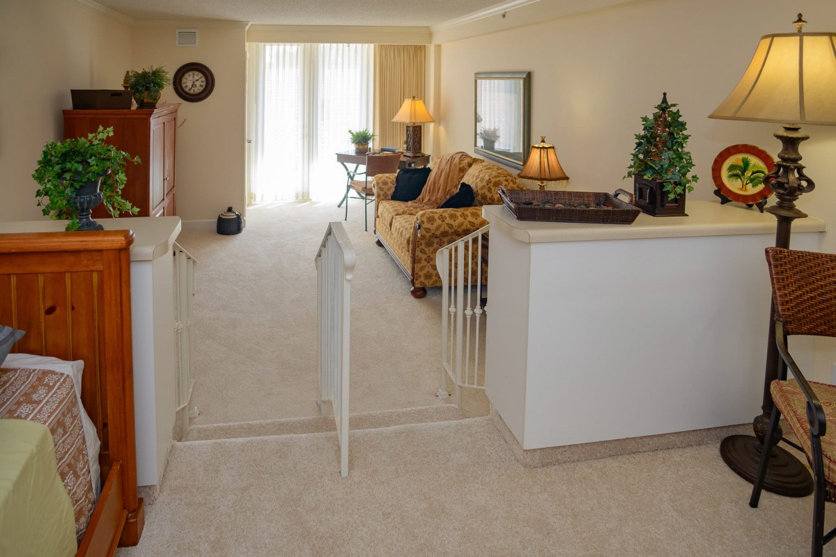 A cozy living room with a sofa, lamps, and decorative elements.