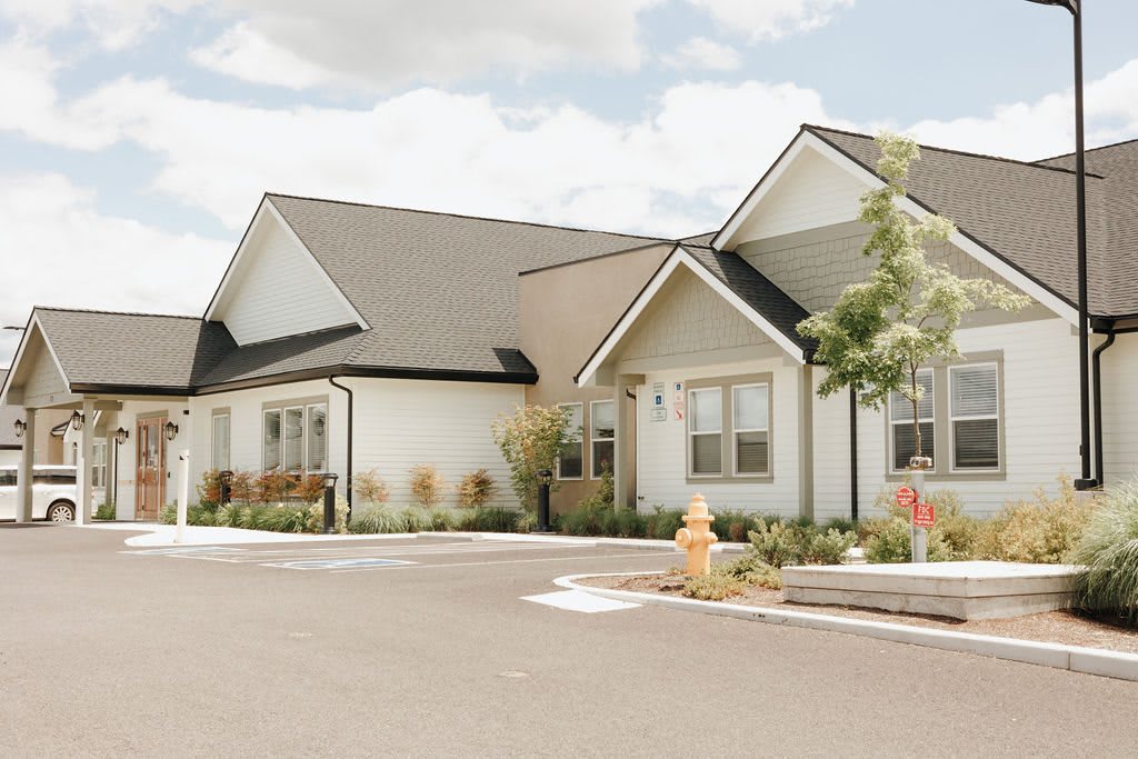 A suburban residential home with a spacious driveway and landscaped surroundings.