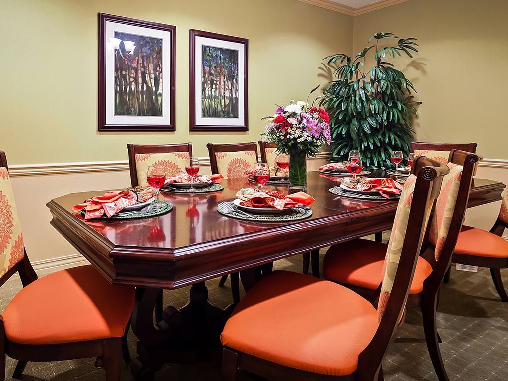 A well-decorated dining room with a set table ready for guests.