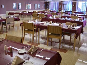 A spacious restaurant dining area set for a meal.