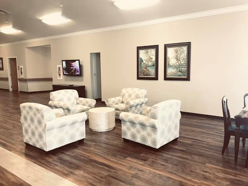 A cozy and inviting lobby space featuring comfortable seating and decorative artwork.