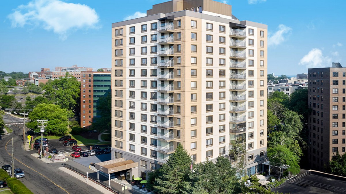 A modern residential apartment building in an urban setting.