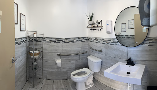 A modern and stylish bathroom featuring essential amenities and accessibility features.
