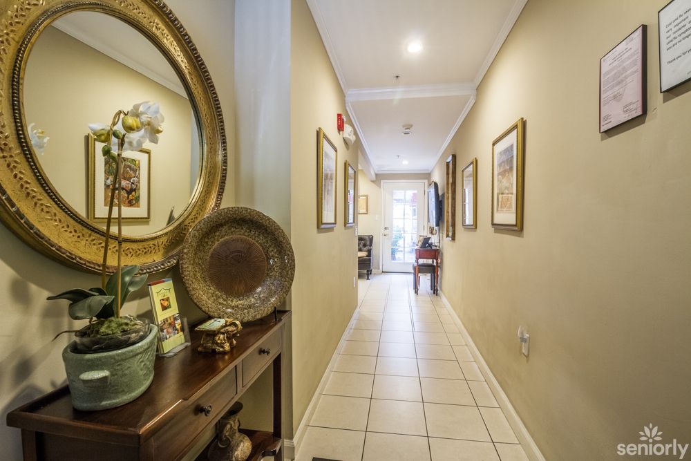 A well-lit hallway with decorative elements and artwork on the walls.