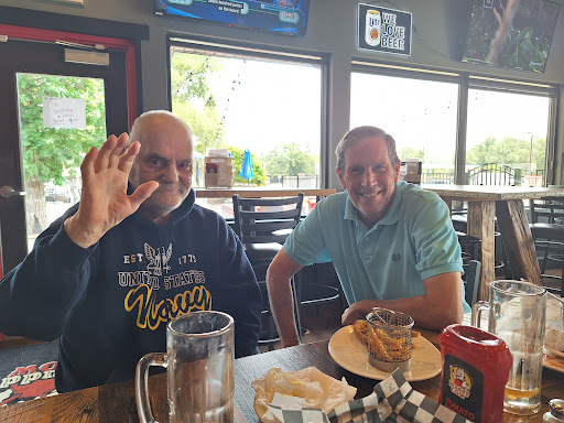 Two friends enjoying a casual meal together at a restaurant.