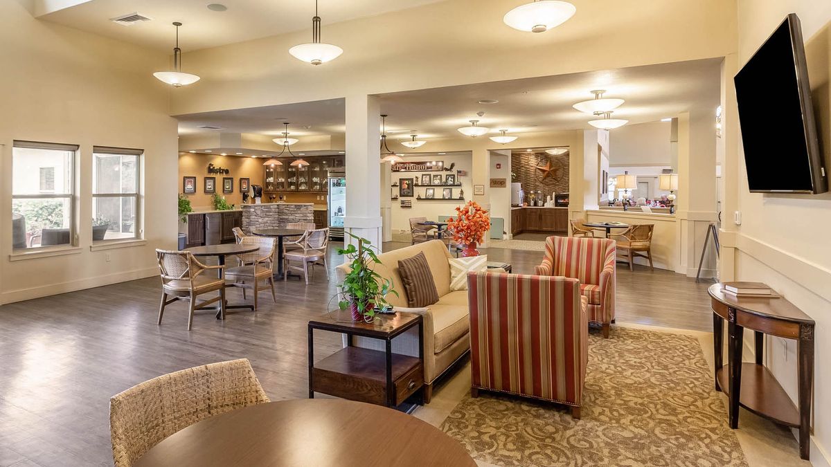 A cozy and modern lounge area with comfortable seating and warm lighting.