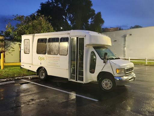 A white bus parked in a parking lot, ready for a new journey.