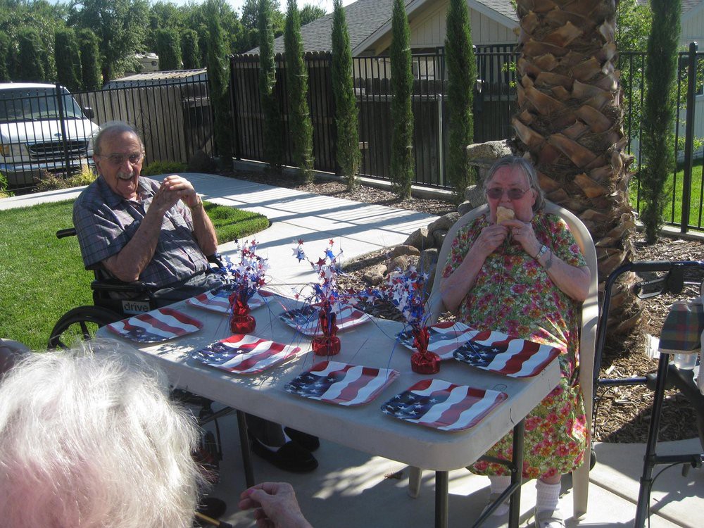 A small outdoor gathering with a patriotic-themed table setting.