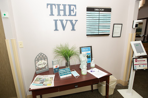 A cozy reception area featuring 'The Ivy' signage and a welcoming desk setup.