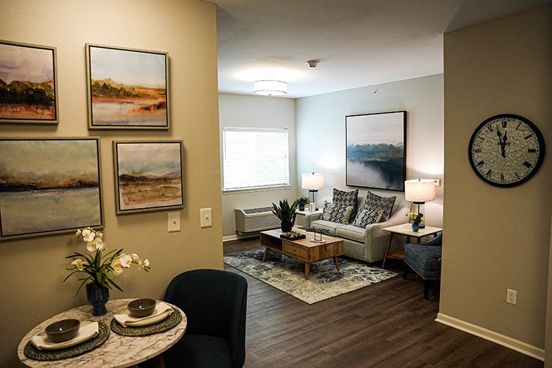 A modern, cozy living room with stylish decor and wooden flooring.