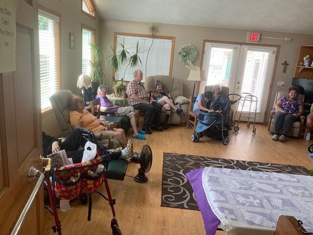 A group of seniors relaxing in a cozy living room environment.