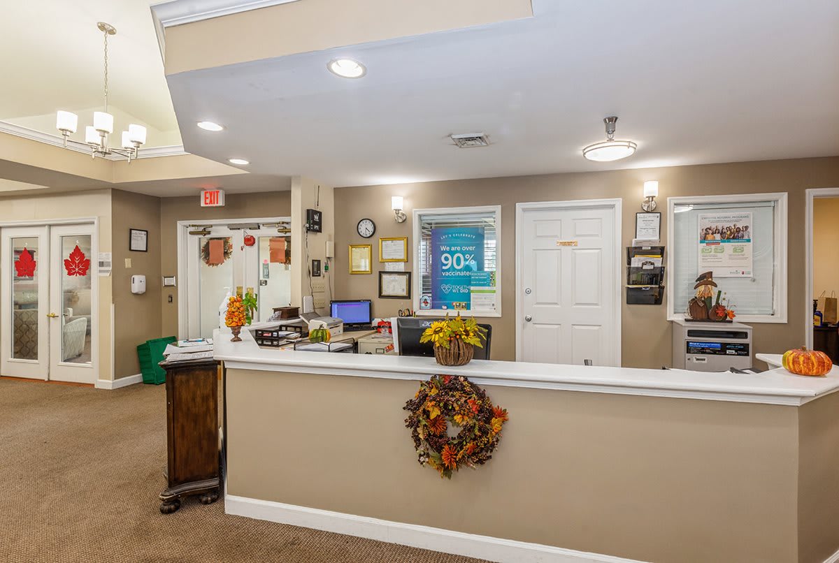 A warmly decorated office reception area with autumn-themed accents.