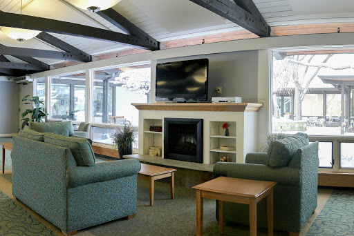 A cozy living room featuring a fireplace, comfortable seating, and a television.