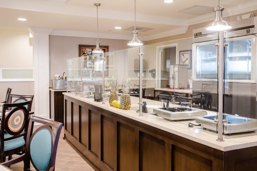 A buffet-style restaurant interior with serving stations and kitchen counters.