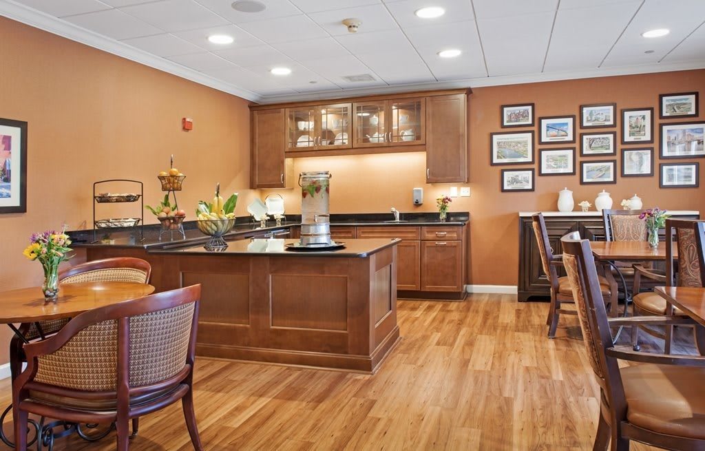 A cozy kitchen and dining area with wooden cabinets and floors.