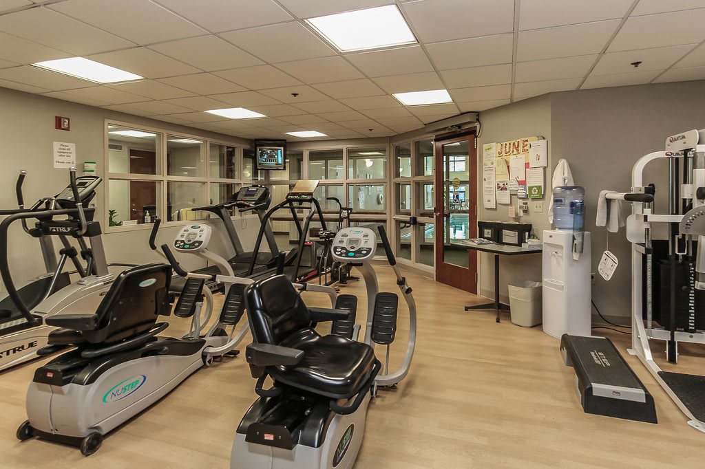 A well-equipped gym with a variety of exercise machines including treadmills and stationary bikes.