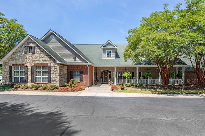 A charming residential building with a well-maintained exterior and landscaped surroundings.