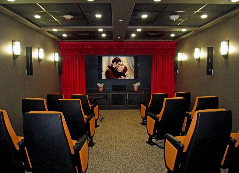 A cozy home theater with comfortable seating and a large movie screen.