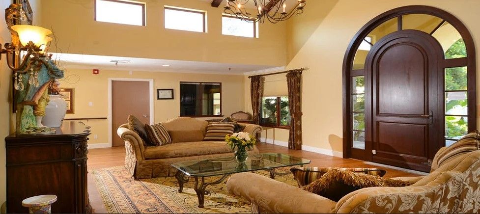 A spacious living room with elegant furniture and warm lighting.