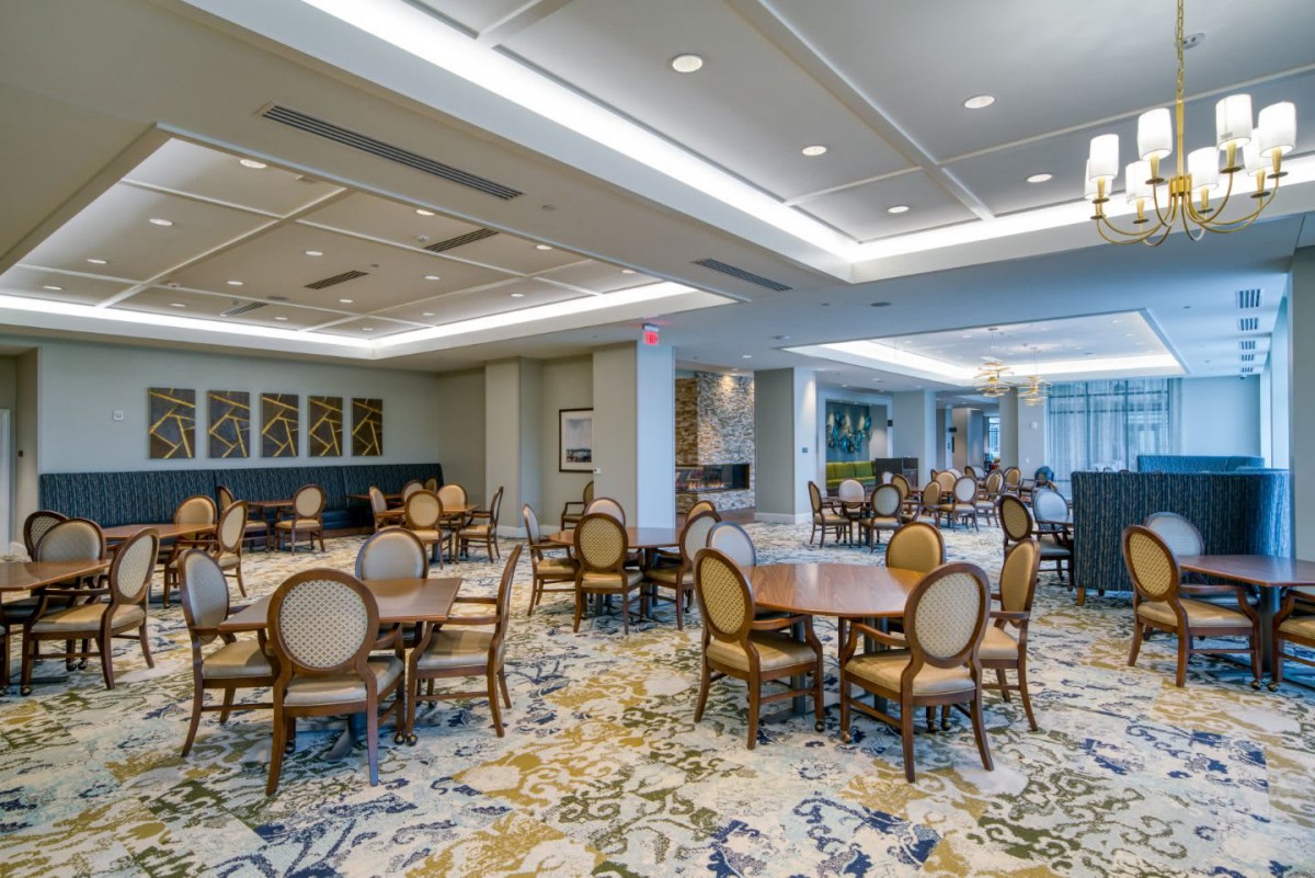 An elegant and modern dining area with neatly arranged tables and chairs.