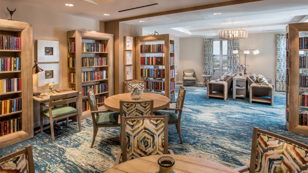 A modern library with comfortable seating and well-organized bookshelves.